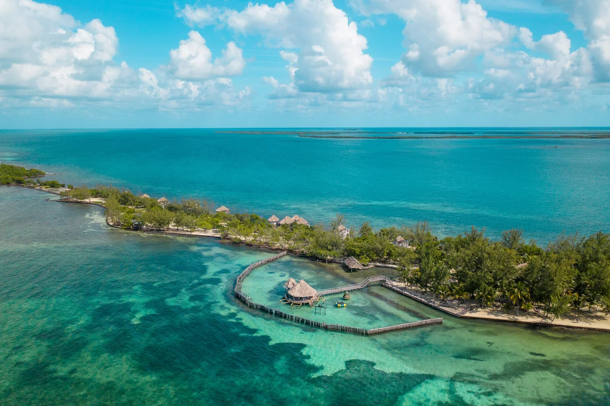 Aerial view of overwatter bungalows at Tatch Caye Resort in Belize