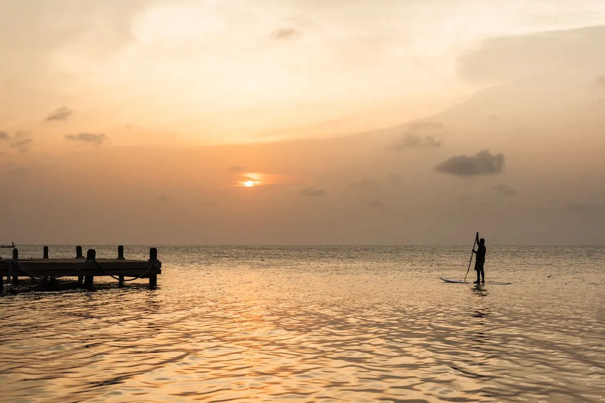 Sunset paddleboarding at Glovers Reef Atoll
