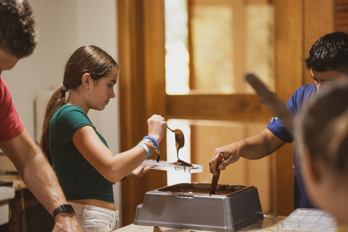 Guest making chocolate bar at Copal Tree Lodge