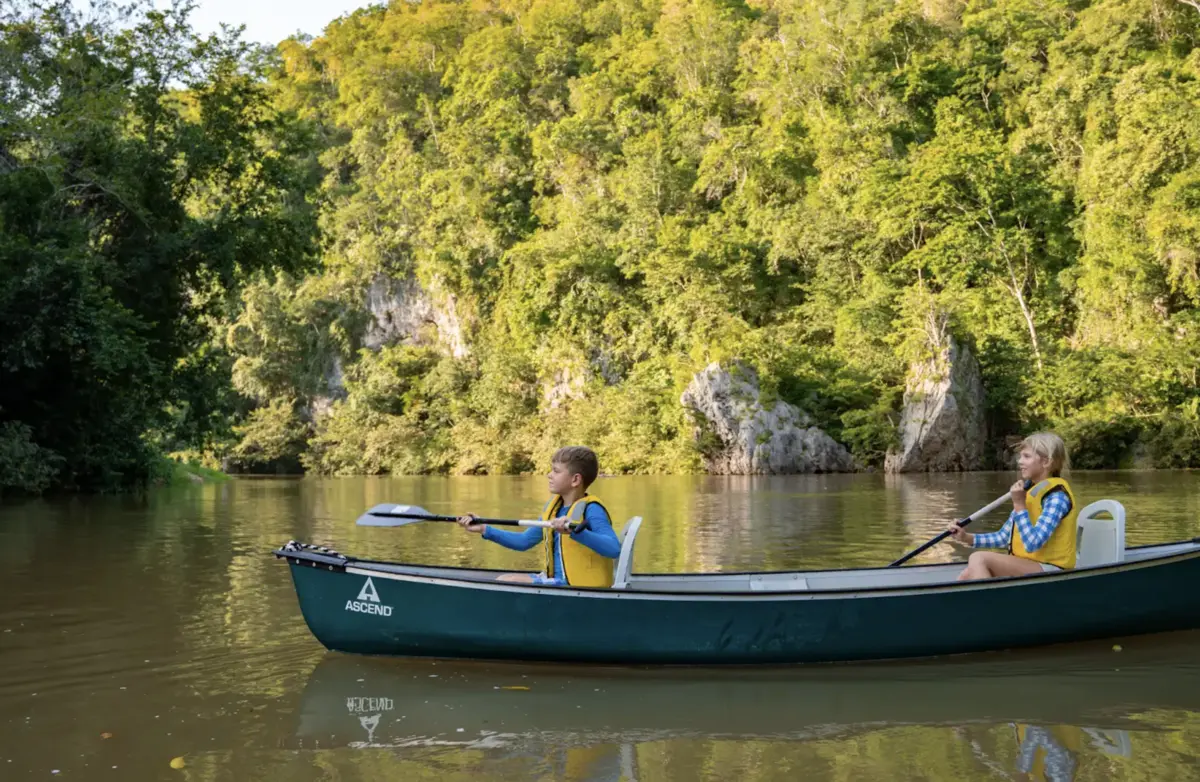 Kids Canoeing on the Macal River at Sweet Songs Jungle Lodge - MuyOno Resorts