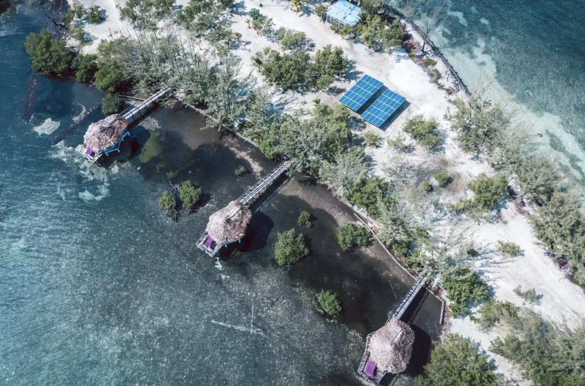 Aerial view of Thatch Cayes solar panels and overwater bungalows | MuyOno Resorts
